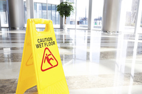 caution wet floor sign on a Premises Liability service page for a florida injury law firm